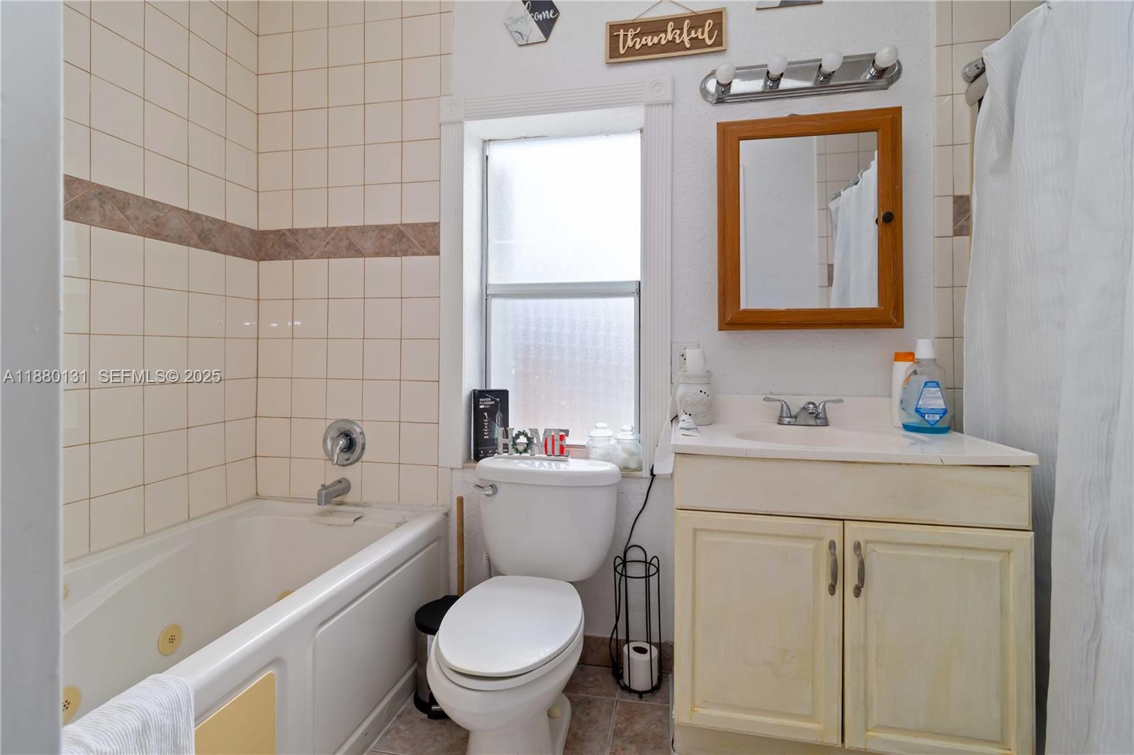 5740 Lincoln Street Hollywood, FL 33021 - Photo 22 of 28 a bathroom with a sink a toilet and bathtub