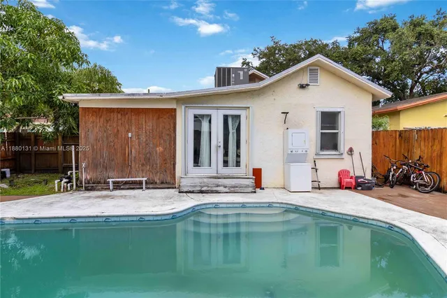 a view of a house with swimming pool and sitting area