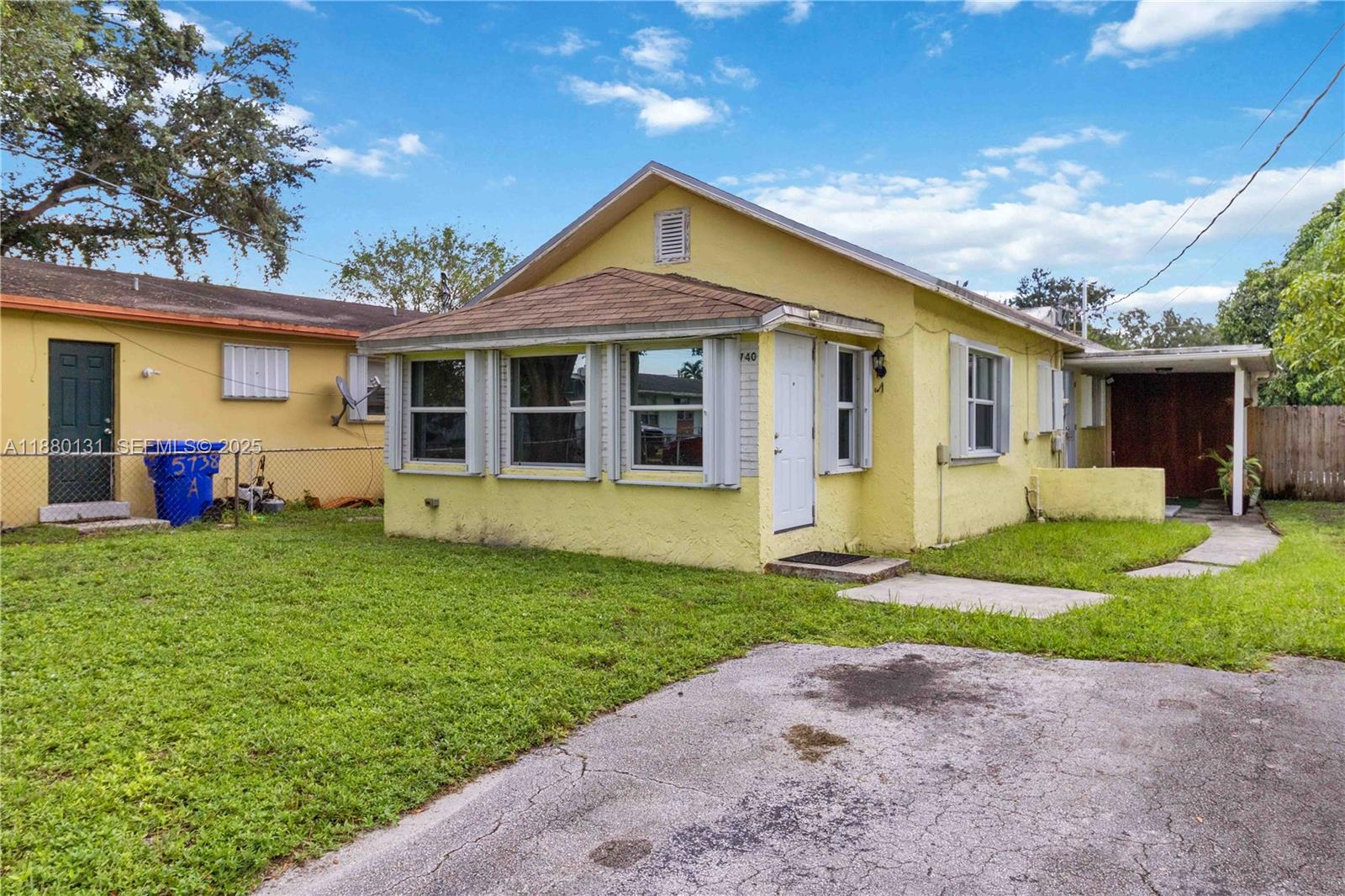5740 Lincoln Street Hollywood, FL 33021 - Photo 3 of 28 a front view of a house with garden