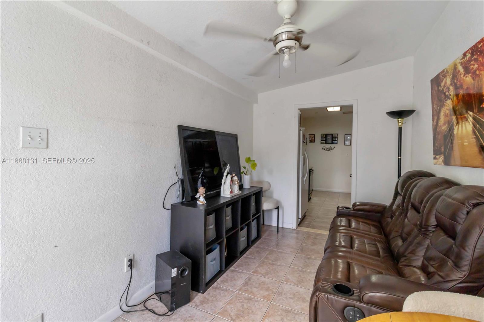 5740 Lincoln Street Hollywood, FL 33021 - Photo 6 of 28 a living room with furniture and a flat screen tv
