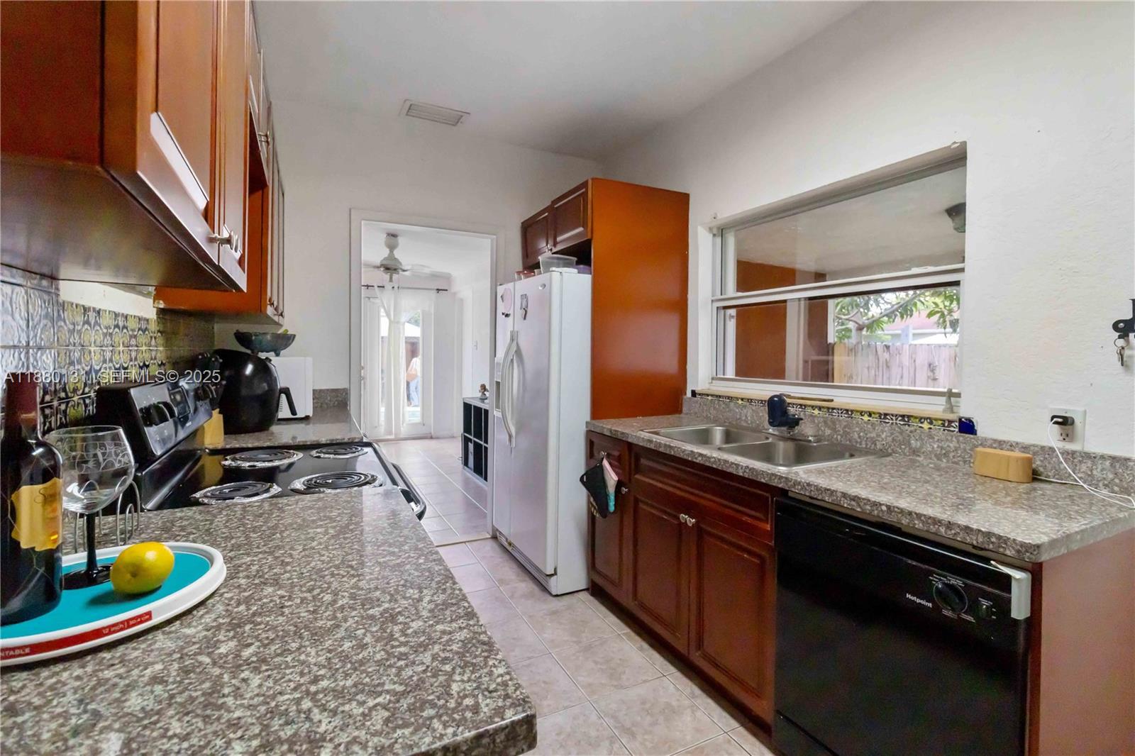 5740 Lincoln Street Hollywood, FL 33021 - Photo 7 of 28 a kitchen with a sink stove and refrigerator