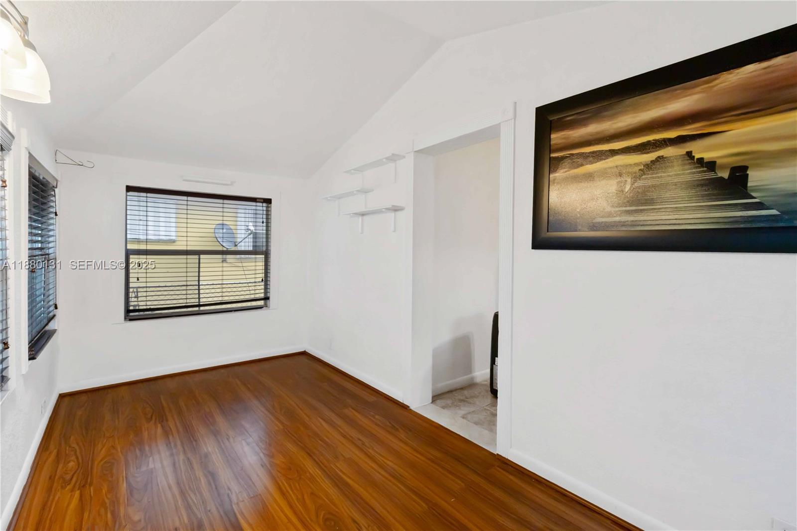 5740 Lincoln Street Hollywood, FL 33021 - Photo 9 of 28 a view of an empty room with wooden floor and a window