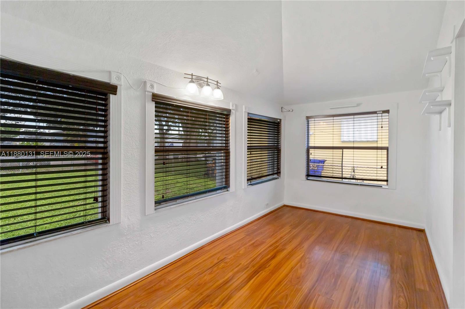5740 Lincoln Street Hollywood, FL 33021 - Photo 10 of 28 a view of an empty room with wooden floor and a window