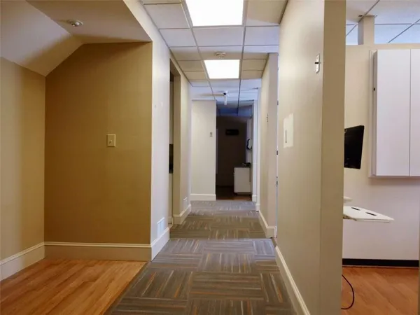 a view of a livingroom with wooden floor and a window