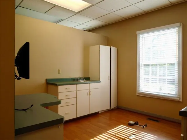 a kitchen with granite countertop white cabinets and white appliances