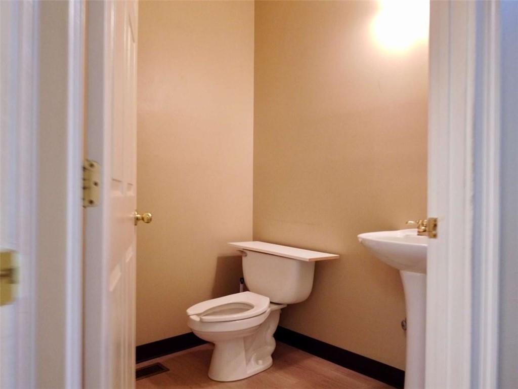 3218 Mill Street Northeast Covington, GA 30014 - Photo 25 of 69 a white toilet sitting next to a bathroom sink