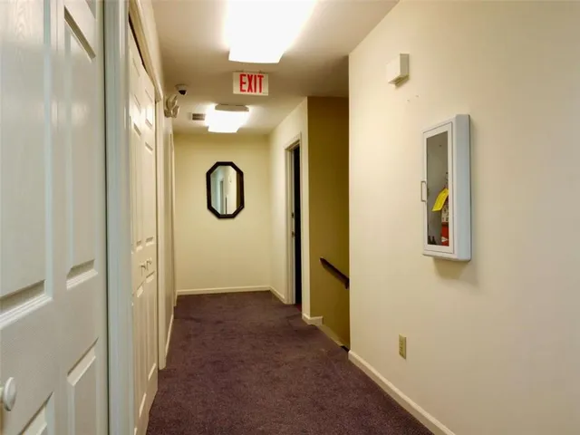 a kitchen with granite countertop white cabinets and window