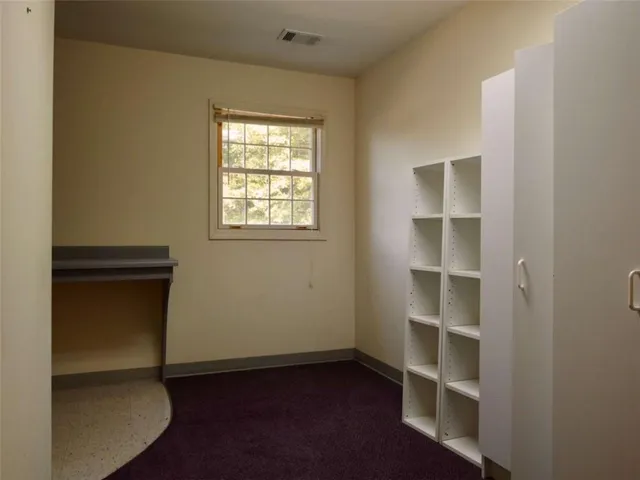 a view of a building with cars parked on road
