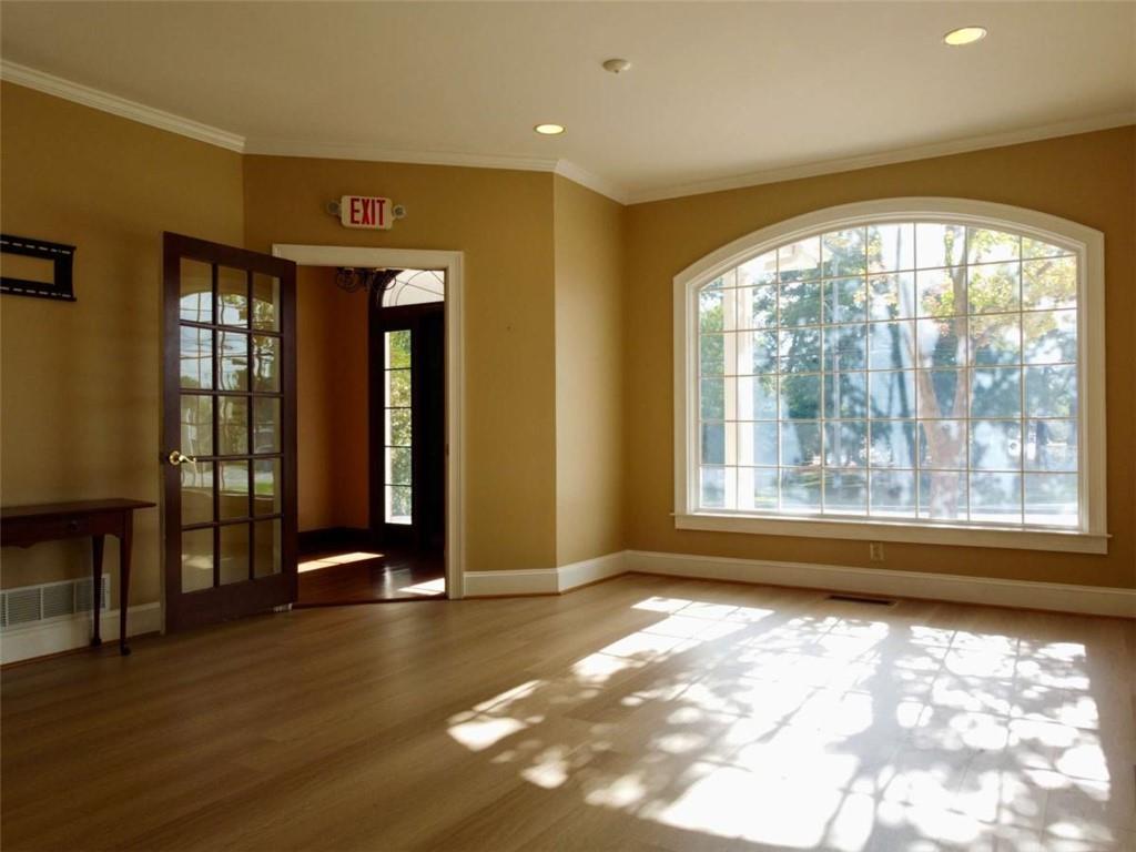 3218 Mill Street Northeast Covington, GA 30014 - Photo 7 of 69 wooden floor in an empty room with a window