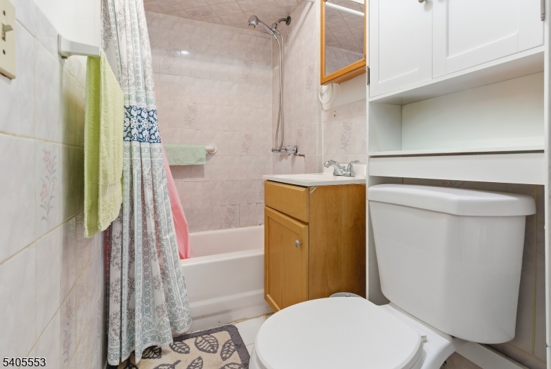 197 16th Avenue Paterson, NJ 07501 - Photo 11 of 23 a bathroom with a sink a toilet and shower
