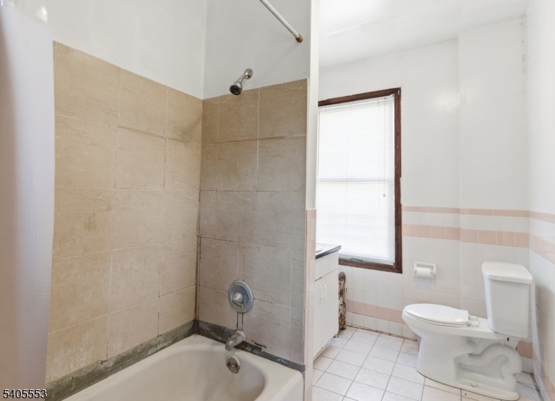 197 16th Avenue Paterson, NJ 07501 - Photo 12 of 23 a bathroom with a sink toilet and shower
