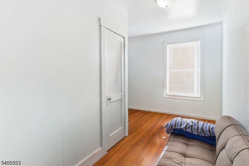 197 16th Avenue Paterson, NJ 07501 - Photo 16 of 23 a living room with a couch and a window