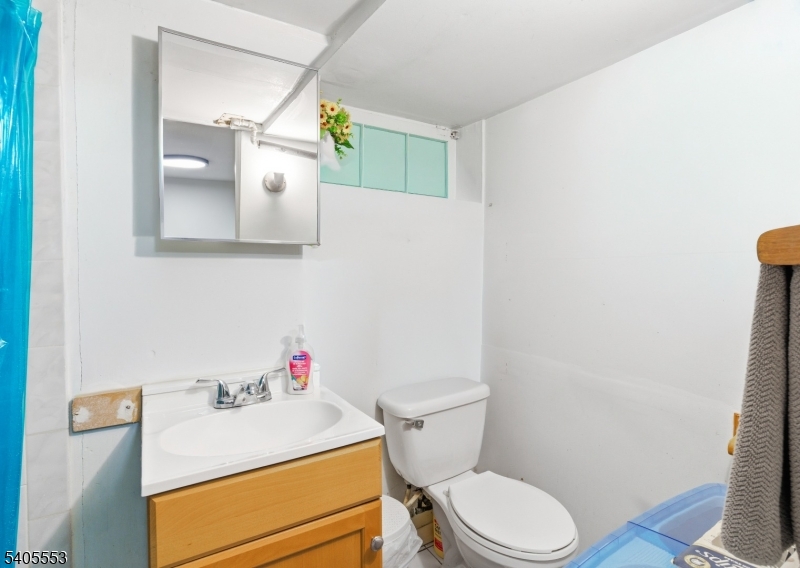 197 16th Avenue Paterson, NJ 07501 - Photo 20 of 23 a white toilet sitting next to a bathroom sink