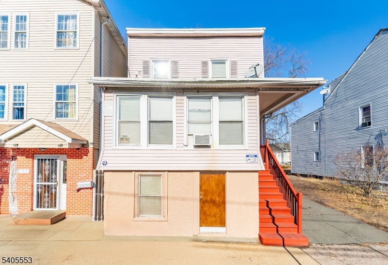 197 16th Avenue Paterson, NJ 07501 - Photo 2 of 23 a front view of a house with a yard