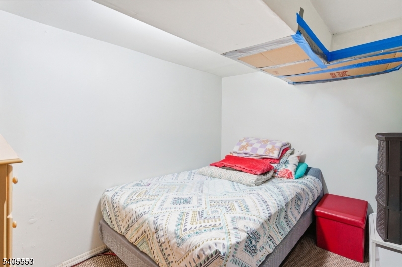 197 16th Avenue Paterson, NJ 07501 - Photo 21 of 23 a bedroom with a bed and a closet