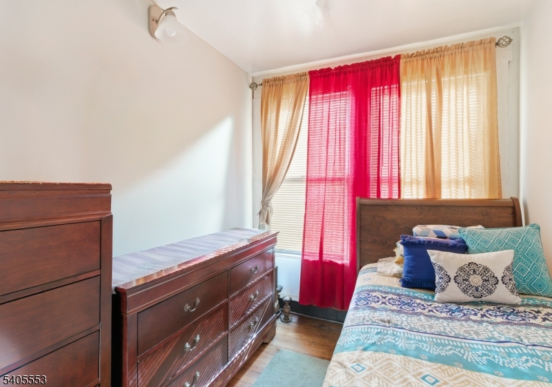 197 16th Avenue Paterson, NJ 07501 - Photo 6 of 23 a bedroom with a bed and windows