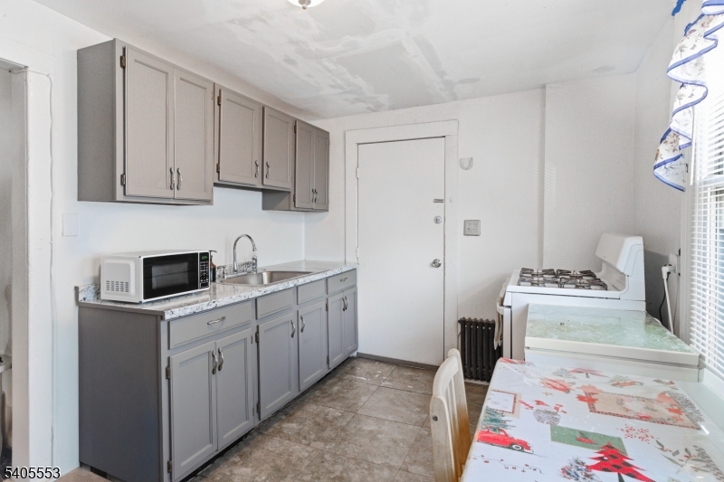 197 16th Avenue Paterson, NJ 07501 - Photo 8 of 23 a kitchen with stainless steel appliances granite countertop a sink stove and cabinets