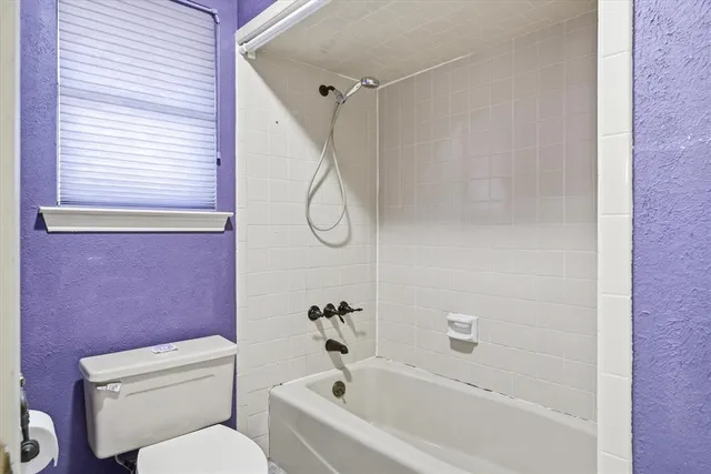 a view of a hallway with wooden floor and cabinet