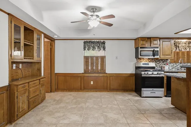 a kitchen with stainless steel appliances granite countertop a stove and cabinets