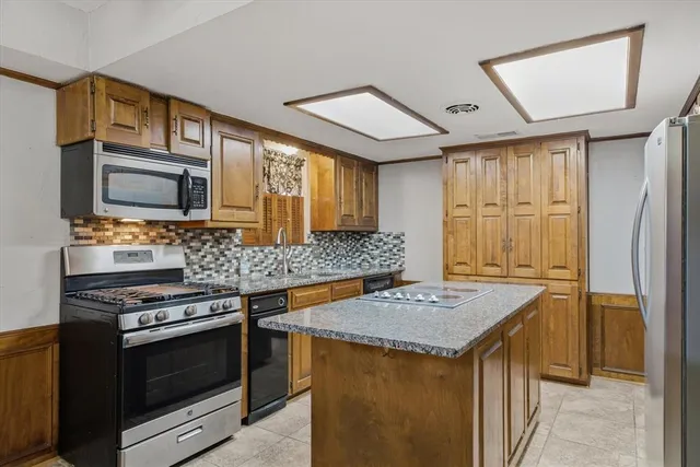 a kitchen that has a stove and a microwave