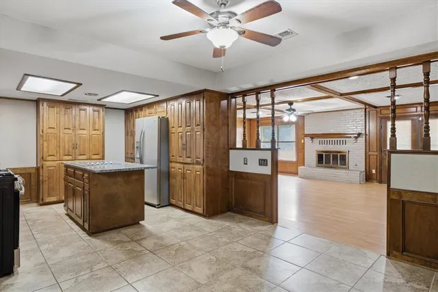 a view of a kitchen with furniture and a ceiling fan