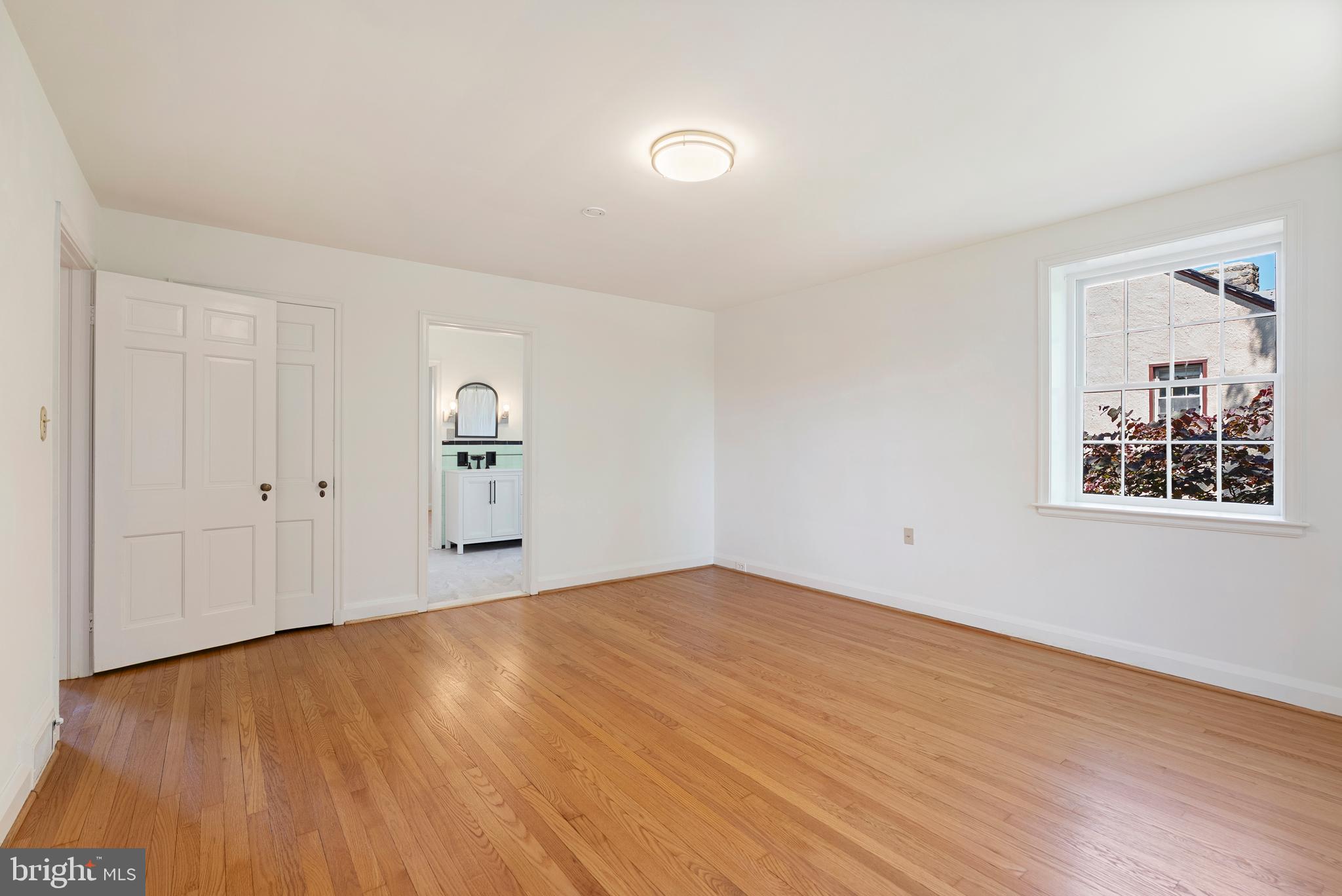 602 Stoneleigh Road Baltimore, MD 21212 - Photo 17 of 31 a view of an empty room with wooden floor and a window
