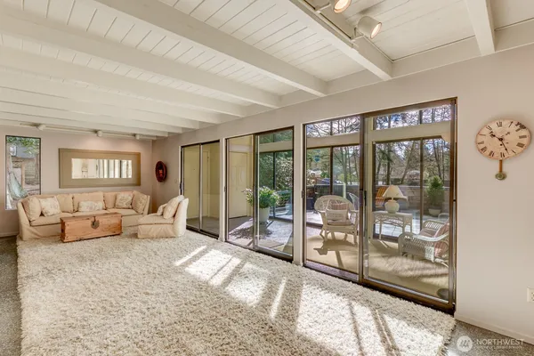 a bedroom with furniture and large windows
