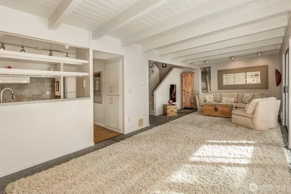 a bedroom with a large bed and a view of living room
