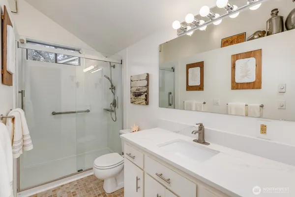 a front view of a house with a tree