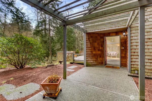 a backyard of a house with barbeque oven table and chairs