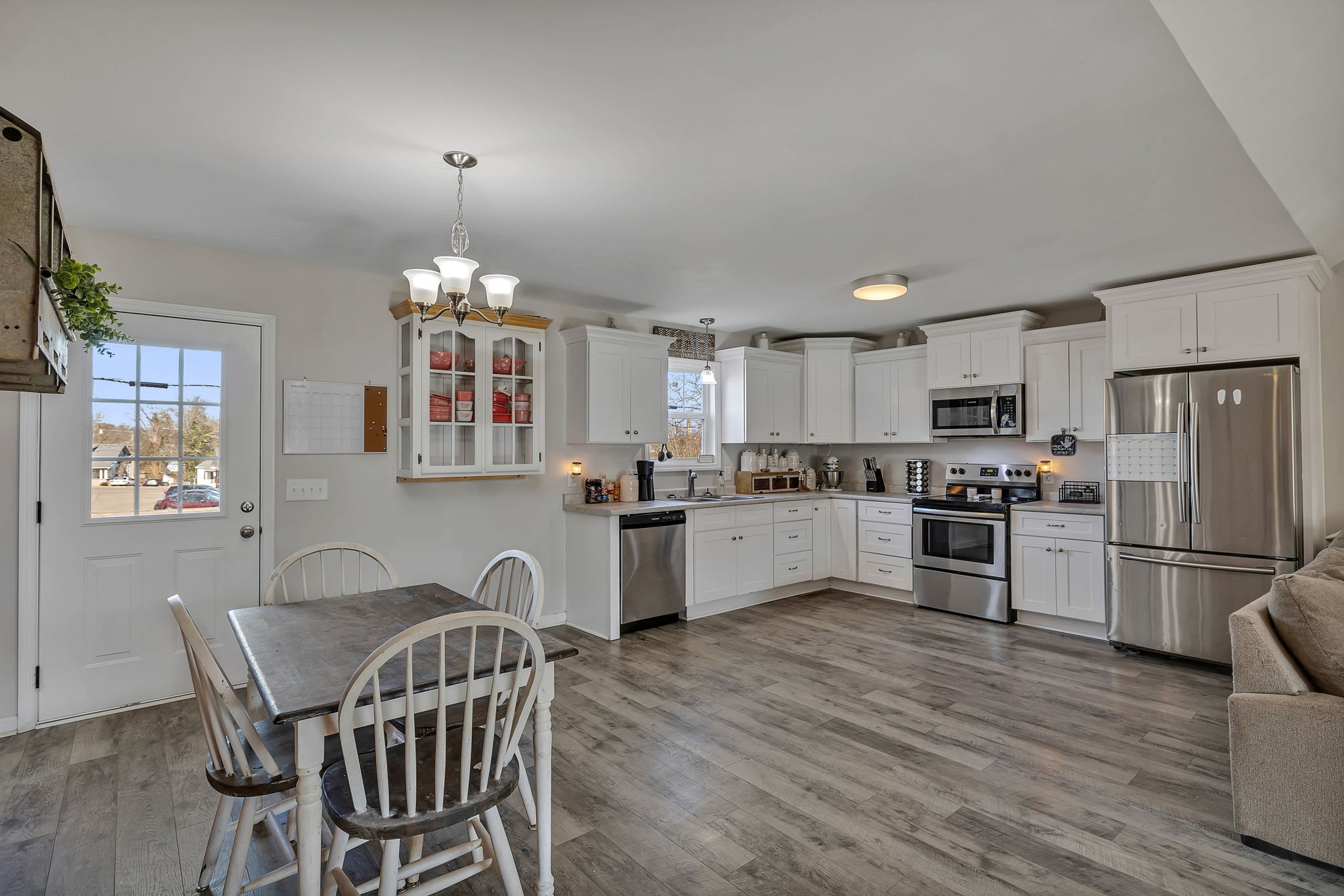 730 Cedar Street Lewisburg, TN 37091 - Photo 20 of 32 a kitchen with a refrigerator cabinets a dining table and chairs