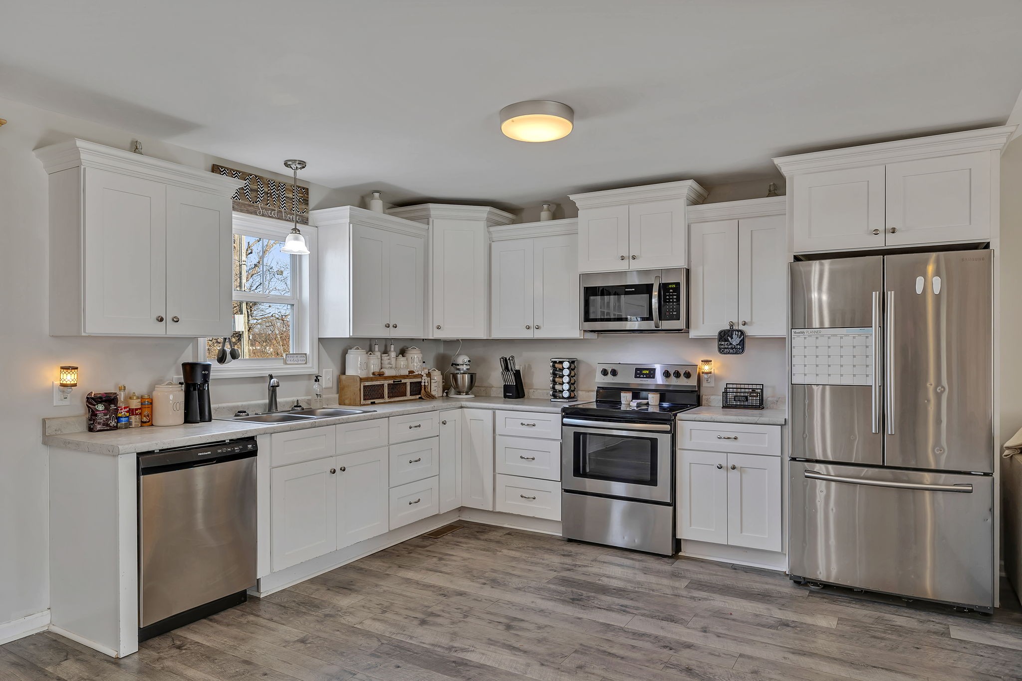 730 Cedar Street Lewisburg, TN 37091 - Photo 21 of 32 a kitchen with white cabinets and stainless steel appliances