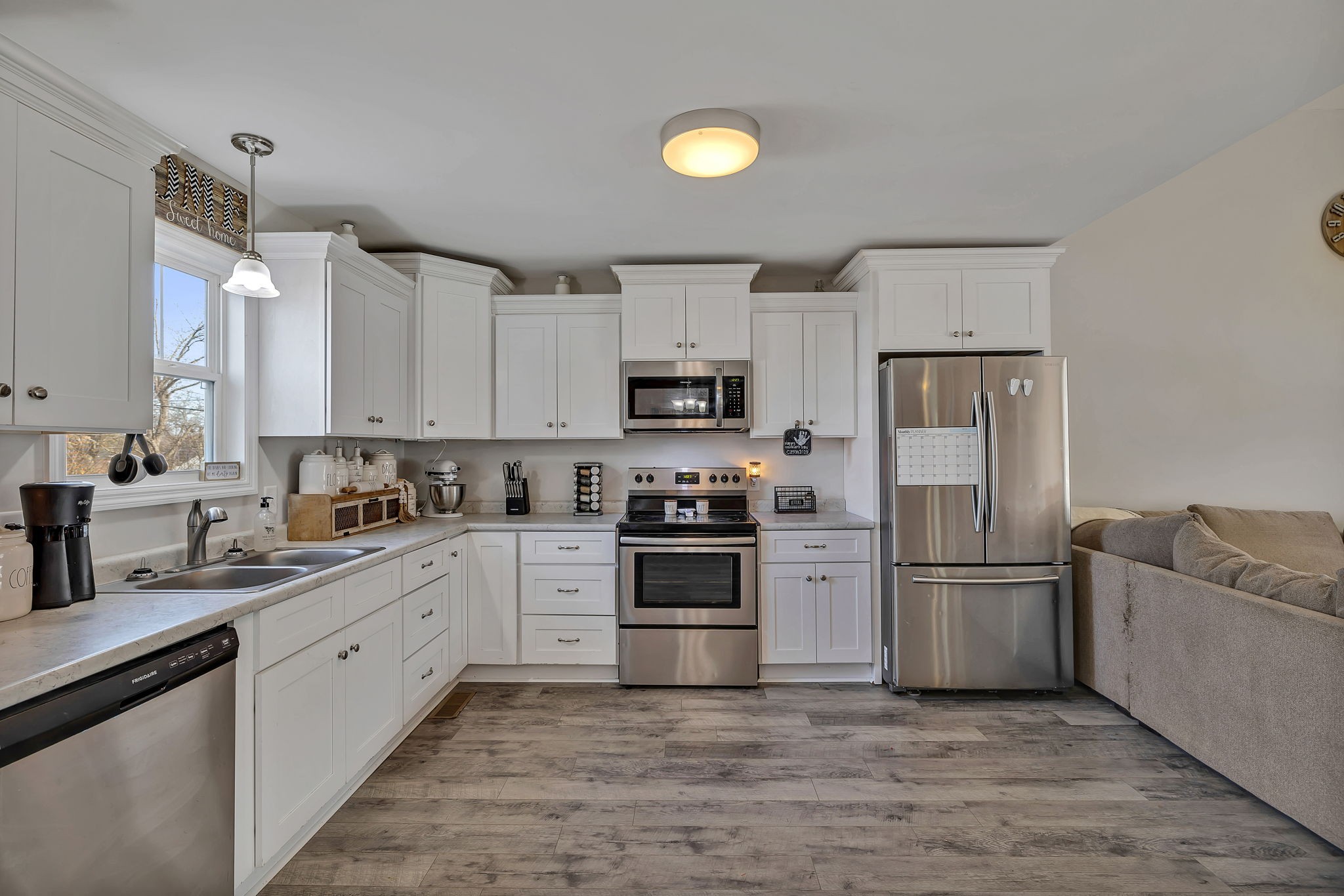 730 Cedar Street Lewisburg, TN 37091 - Photo 22 of 32 a kitchen with white cabinets and stainless steel appliances