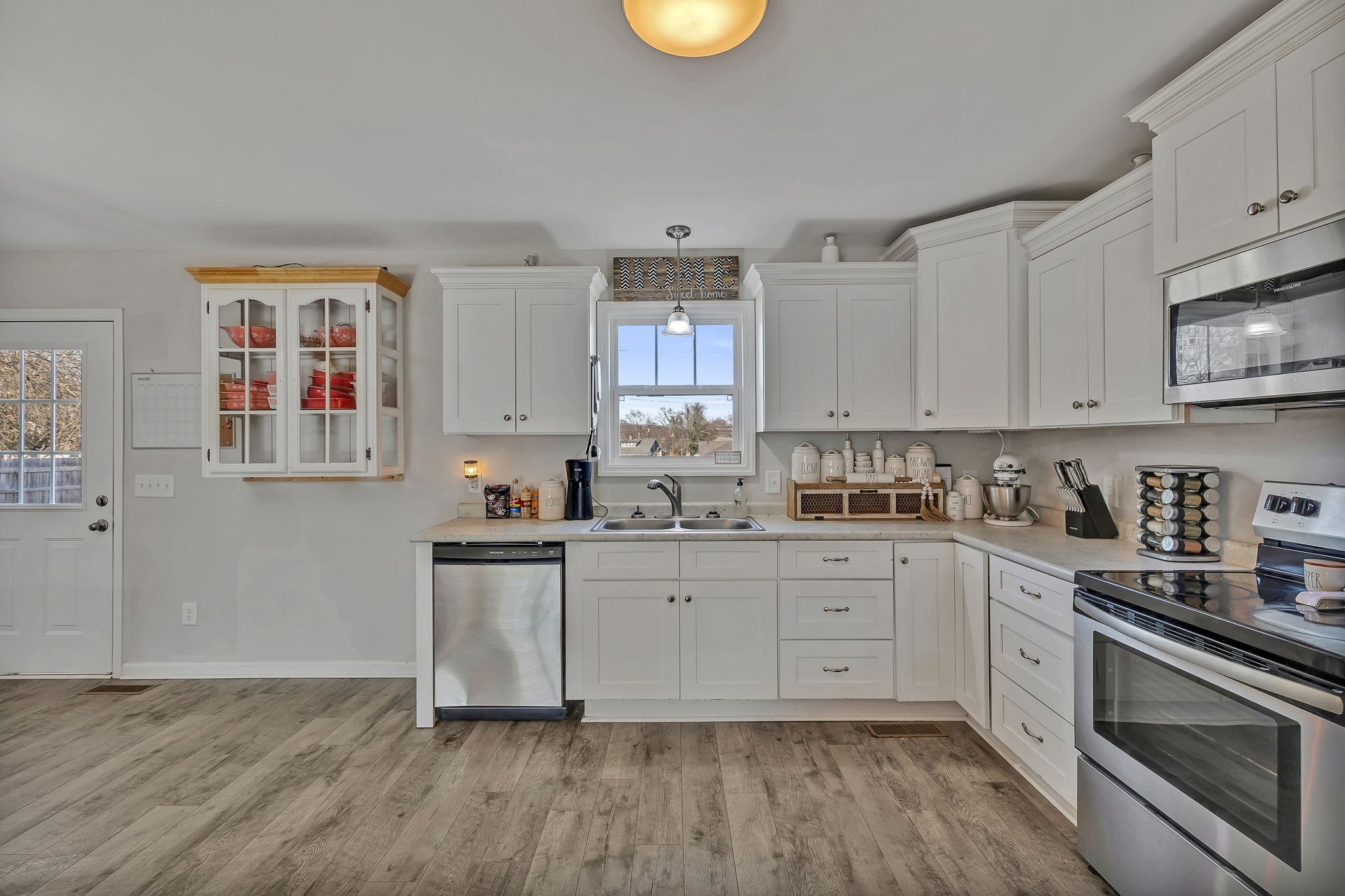 730 Cedar Street Lewisburg, TN 37091 - Photo 23 of 32 a kitchen with cabinets wooden floor and stainless steel appliances