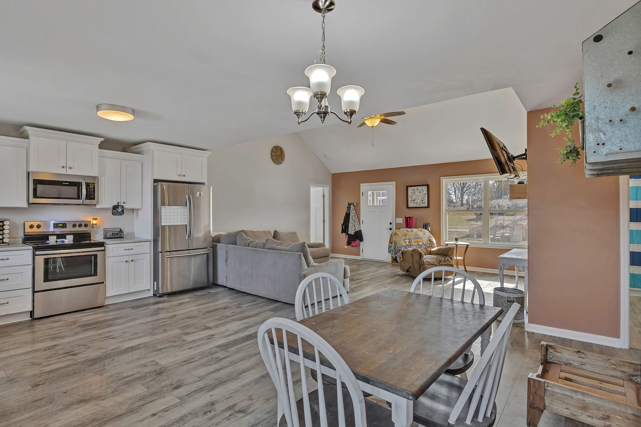 730 Cedar Street Lewisburg, TN 37091 - Photo 26 of 32 a dining room with wooden floor a chandelier a wooden table and chairs
