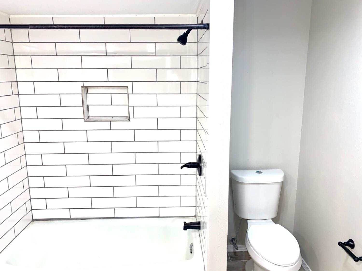 5708 91st Street Lubbock, TX 79424 - Photo 15 of 26 a bathroom with a toilet and a shower