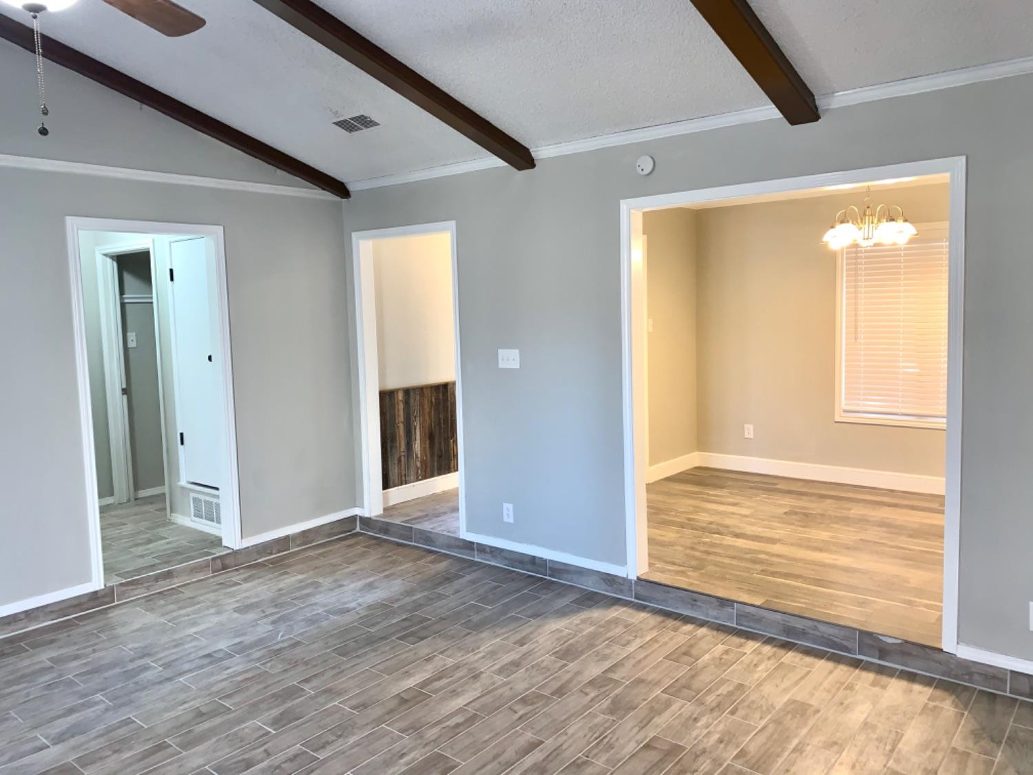 5708 91st Street Lubbock, TX 79424 - Photo 5 of 26 an empty room with wooden floor and windows
