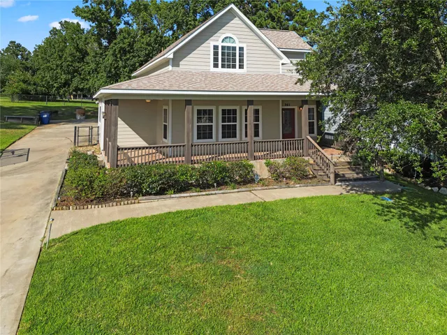 a front view of a house with a garden and yard