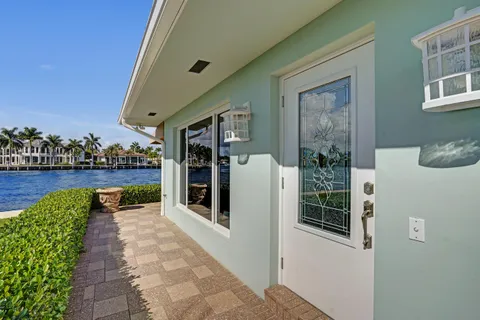 a view of a house with a chairs and table in a patio