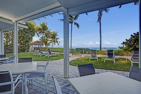 a view of a patio with a table chairs and a backyard