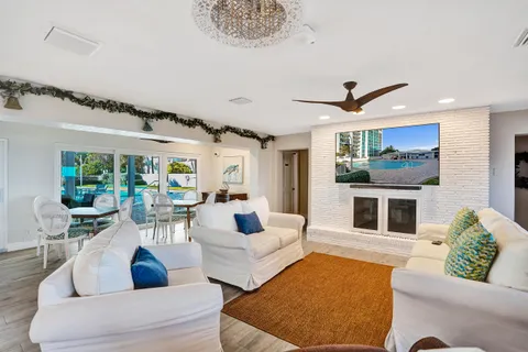 a living room with furniture ceiling fan and a rug