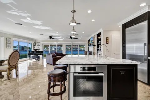 a kitchen with a table chairs stove and wooden floor