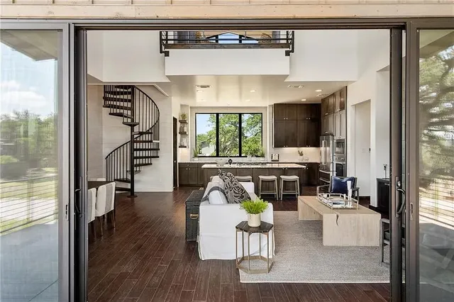 a living room with furniture and a floor to ceiling window