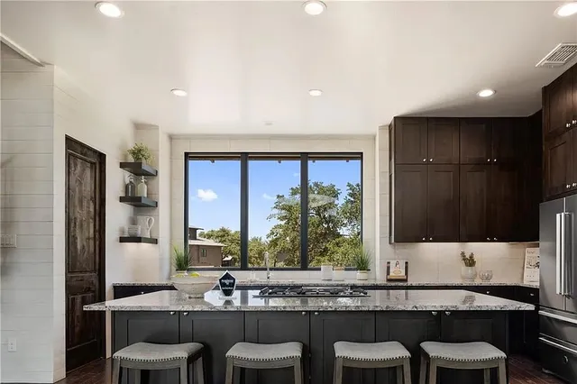 a bathroom with a granite countertop sink and a large mirror