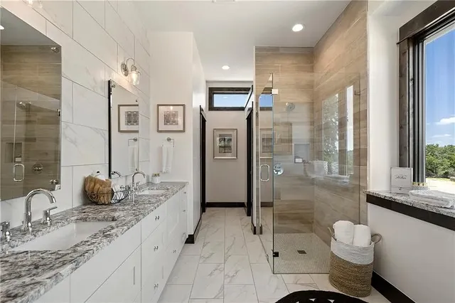 a bathroom with a granite countertop sink toilet and shower