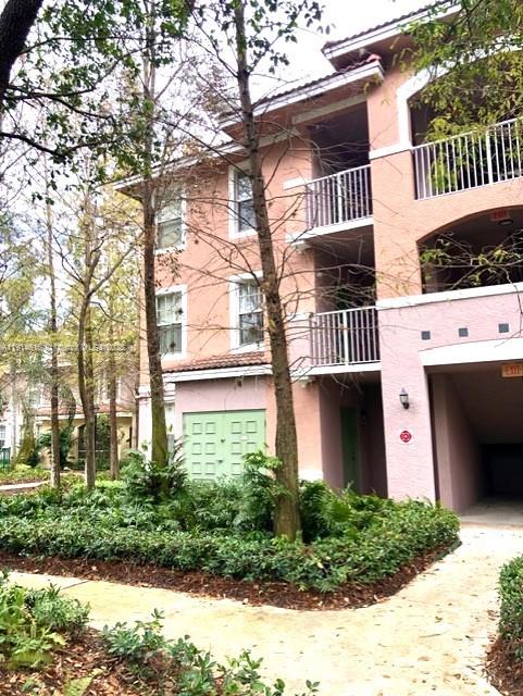 6584 West Sample Road, Unit 6584 Coral Springs, FL 33067 - Photo 1 of 13 a front view of a house with a yard