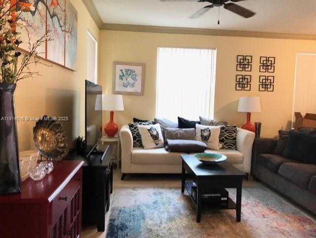 6584 West Sample Road, Unit 6584 Coral Springs, FL 33067 - Photo 2 of 13 a living room with furniture a rug and a painting on the wall
