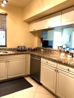 6584 West Sample Road, Unit 6584 Coral Springs, FL 33067 - Photo 5 of 13 a kitchen with stainless steel appliances granite countertop a sink and a stove