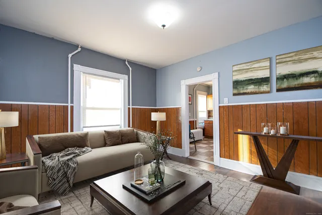 a living room with a couch and a window