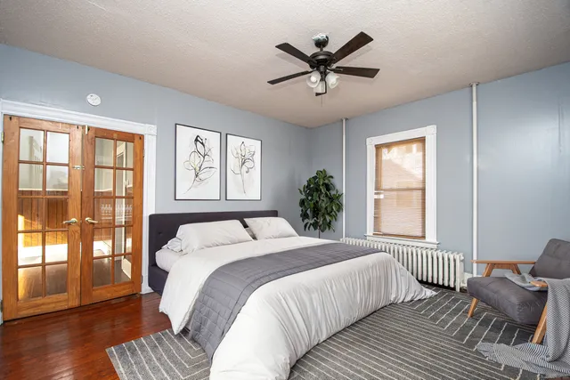 a bedroom with a large bed and a window